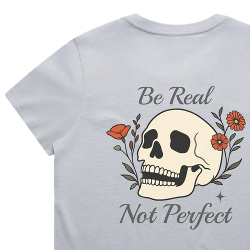 Light blue t-shirt with a skull design and text 'Be Real Not Perfect' on a white background
