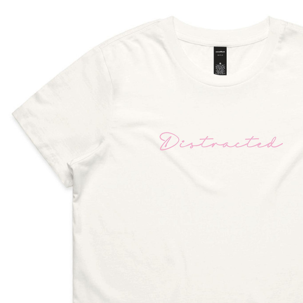White t-shirt with 'Distracted' text in pink on a white background