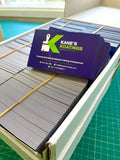 Kane's Coatings fridge magnets on a table with a cutting mat