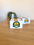 Full colour double sided business cards for Poultons Garage featuring a green circular logo with a yellow ute on a white background