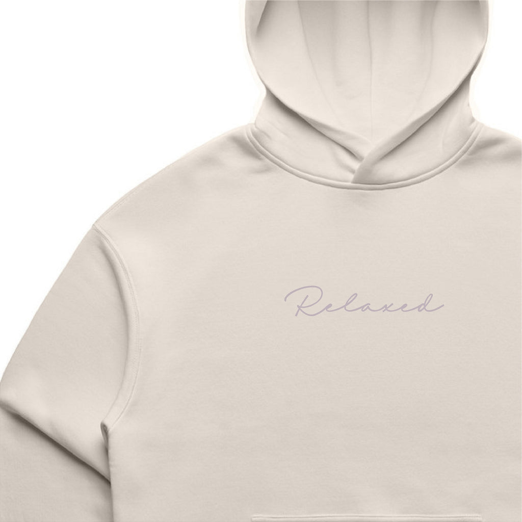 Beige hoodie with 'Relaxed' text on a white background
